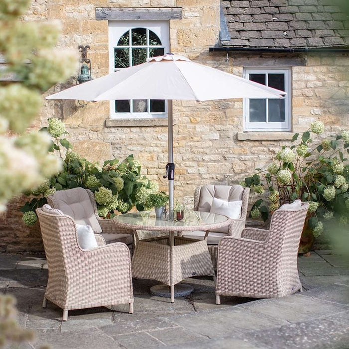 Bramblecrest Chedworth 4 Seat Garden Dining Set in Sandstone with Round Table, Parasol & Base
