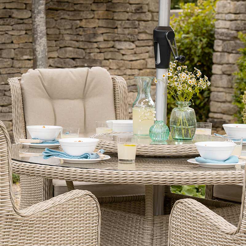 Bramblecrest Chedworth 4 Seat Garden Dining Set in Sandstone with Round Table, Parasol & Base