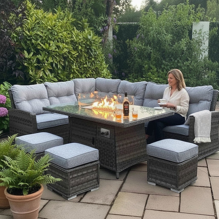 Mid Ulster Garden Centre Amalfi dark grey rattan corner sofa set with a rectangular gas firepit table on a patio.