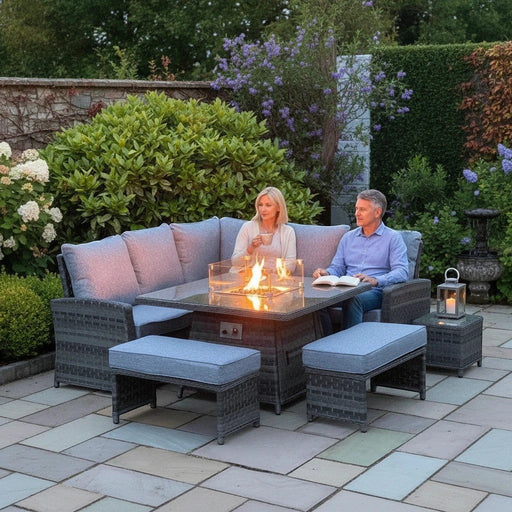 Mid Ulster Garden Centre Amalfi dark grey rattan corner sofa set with integrated glass firepit on a stone patio.