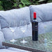Mid Ulster Garden Centre Amalfi dark grey rattan dining set with wine bottle and glasses on glass firepit table