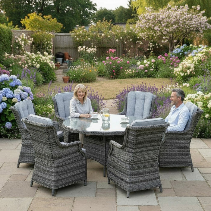 Mid Ulster Garden Centre Amalfi 6-seat round grey rattan dining set with high-back chairs on a stone patio.
