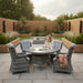 Mid Ulster Garden Centre Amalfi grey rattan 4-seat dining set with high-back chairs and glass-top table on a patio.