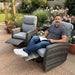 Man relaxing in a Mid Ulster Garden Centre Amalfi grey wicker recliner chair in a lush garden setting.