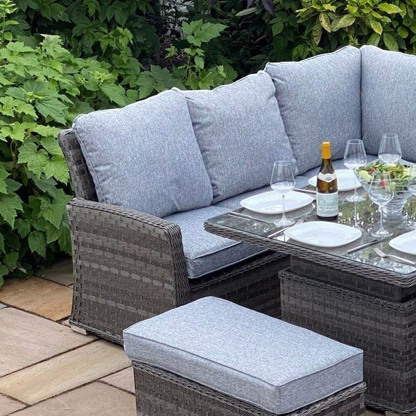 Mid Ulster Garden Centre Amalfi corner sofa set with grey cushions, rattan weave, and adjustable height dining table.