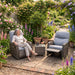 Mid Ulster Garden Centre Amalfi recliner bistro set with grey weave chairs and glass table in a lush garden setting.