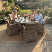 Mid Ulster Garden Centre Hampton 6 seat light brown synthetic rattan dining set with round glass table in a garden