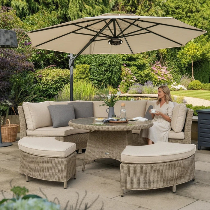 Mid Ulster Garden Centre Kettler Palma round wicker sofa set in oyster with stone cushions and parasol on a patio
