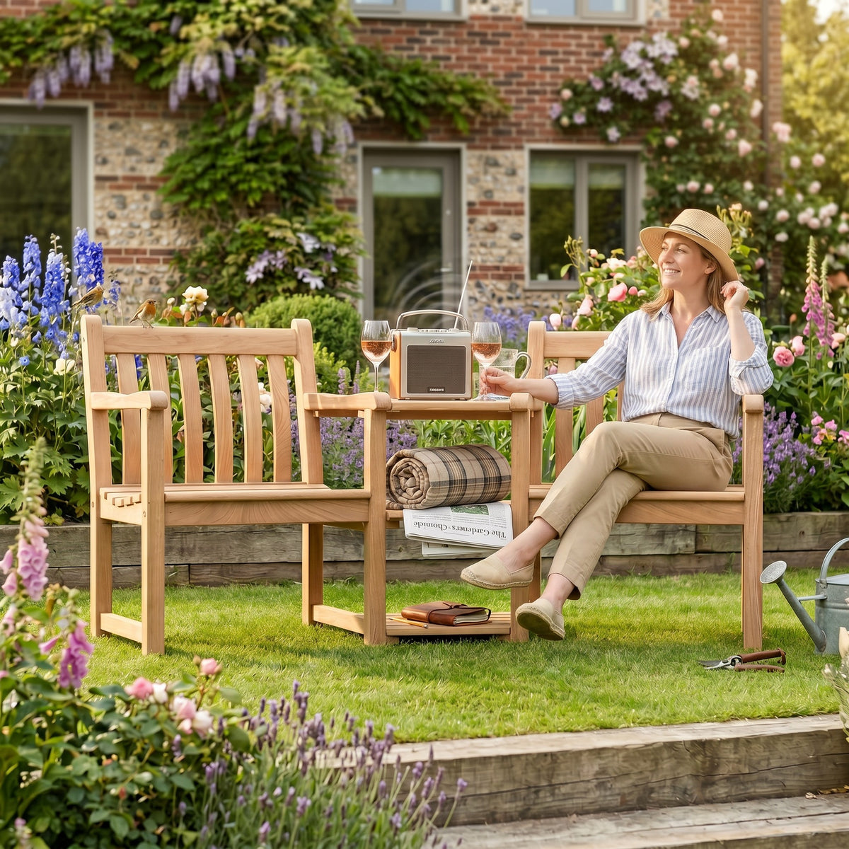 Mid Ulster Garden Centre Alexander Rose Roble companion set with a woman relaxing in a lush garden setting.